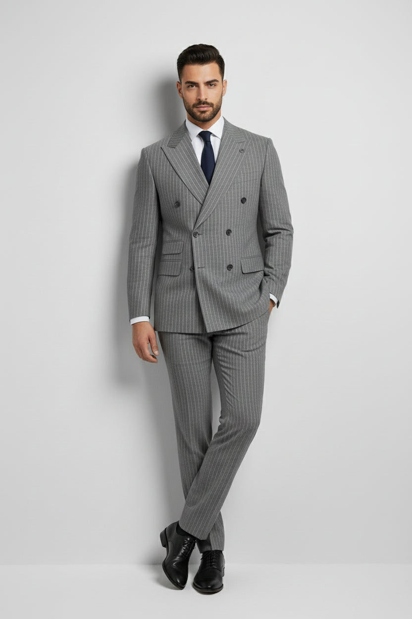 Man wearing gray pinstripe double-breasted suit with tailored fit and tie.
