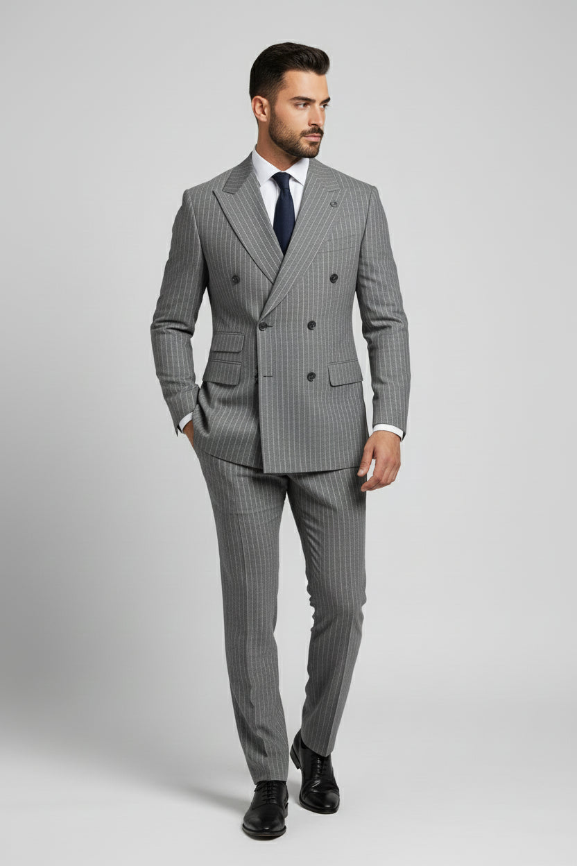 Man wearing gray pinstripe double-breasted suit, tailored for formal occasions.