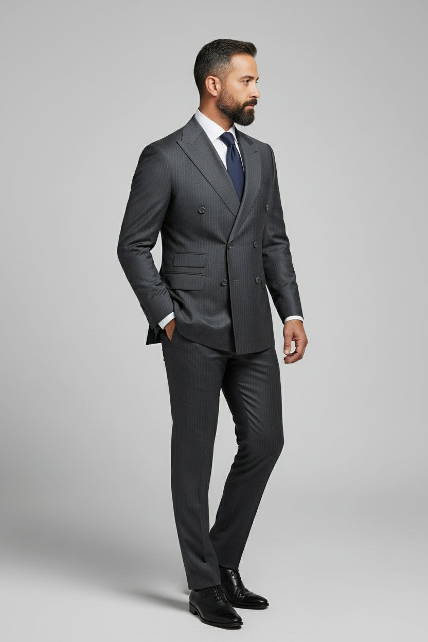 Man wearing charcoal pinstripe double-breasted suit with tailored fit and stylish tie.