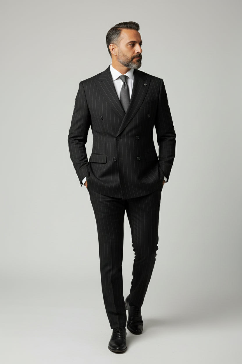 Man wearing elegant black pinstripe double-breasted suit with tailored fit.