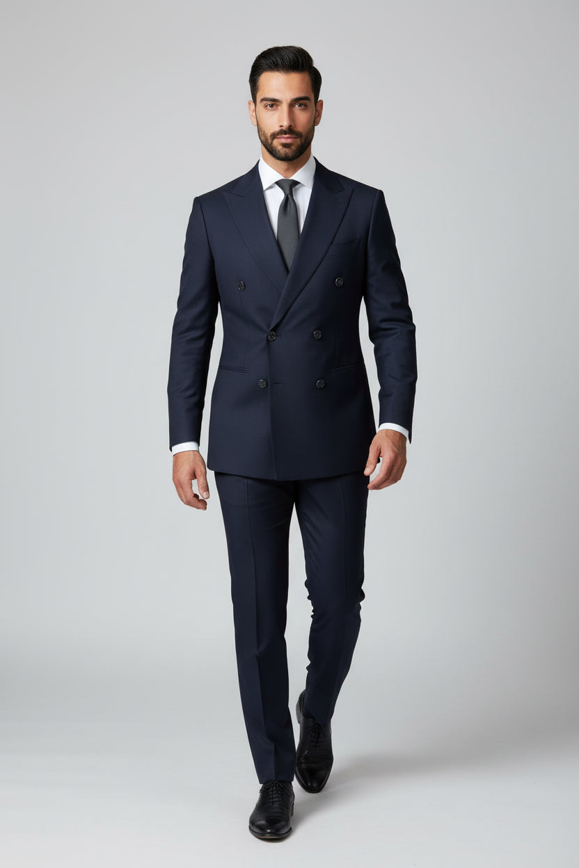 Man wearing navy double-breasted slim-fit suit with tailored design and tie.