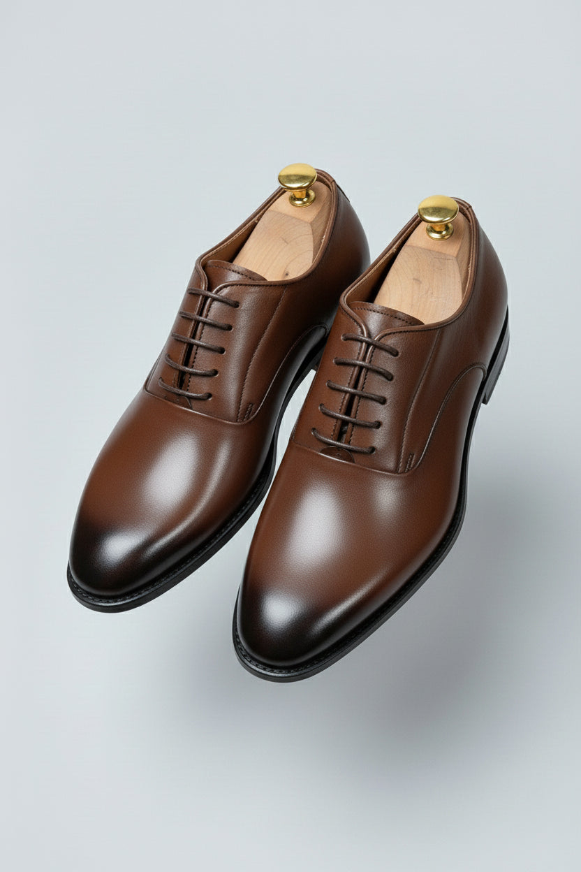 Brown leather classic derby shoes with lace-up design for formal occasions.
