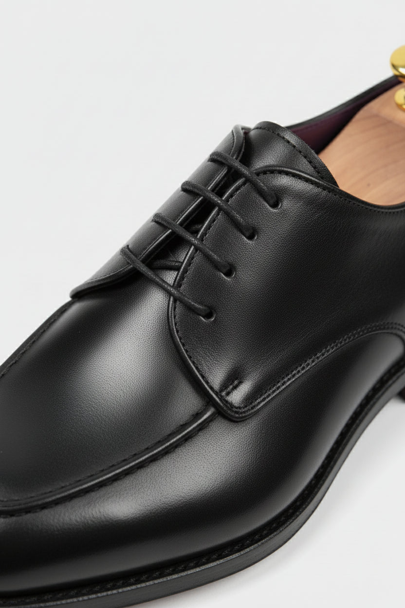 Black leather lace-up dress shoes with classic design for formal and smart casual wear.