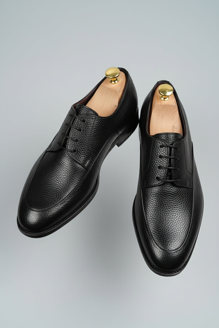 Black leather lace-up dress shoes with textured finish, ideal for formal occasions.