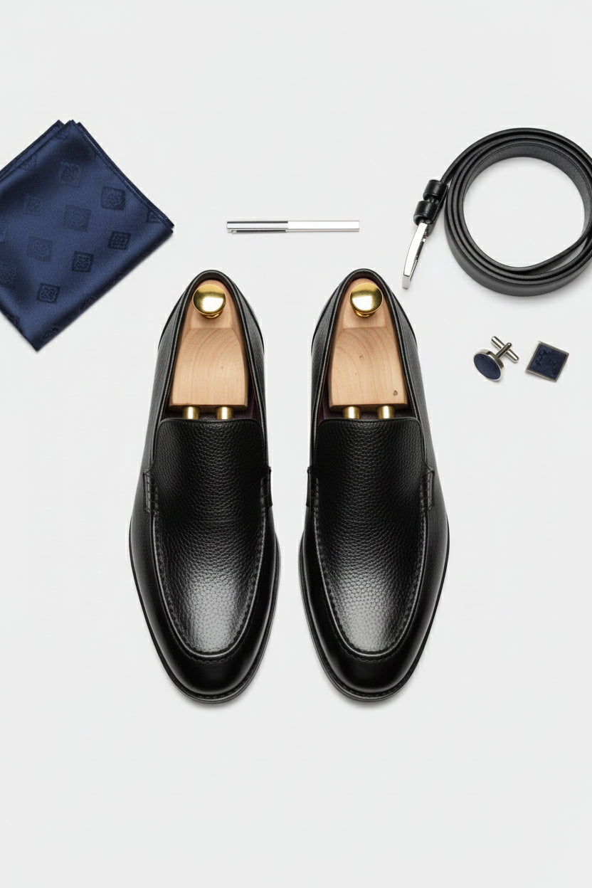 Black slip-on leather tuxedo shoes with elegant design for formal occasions.