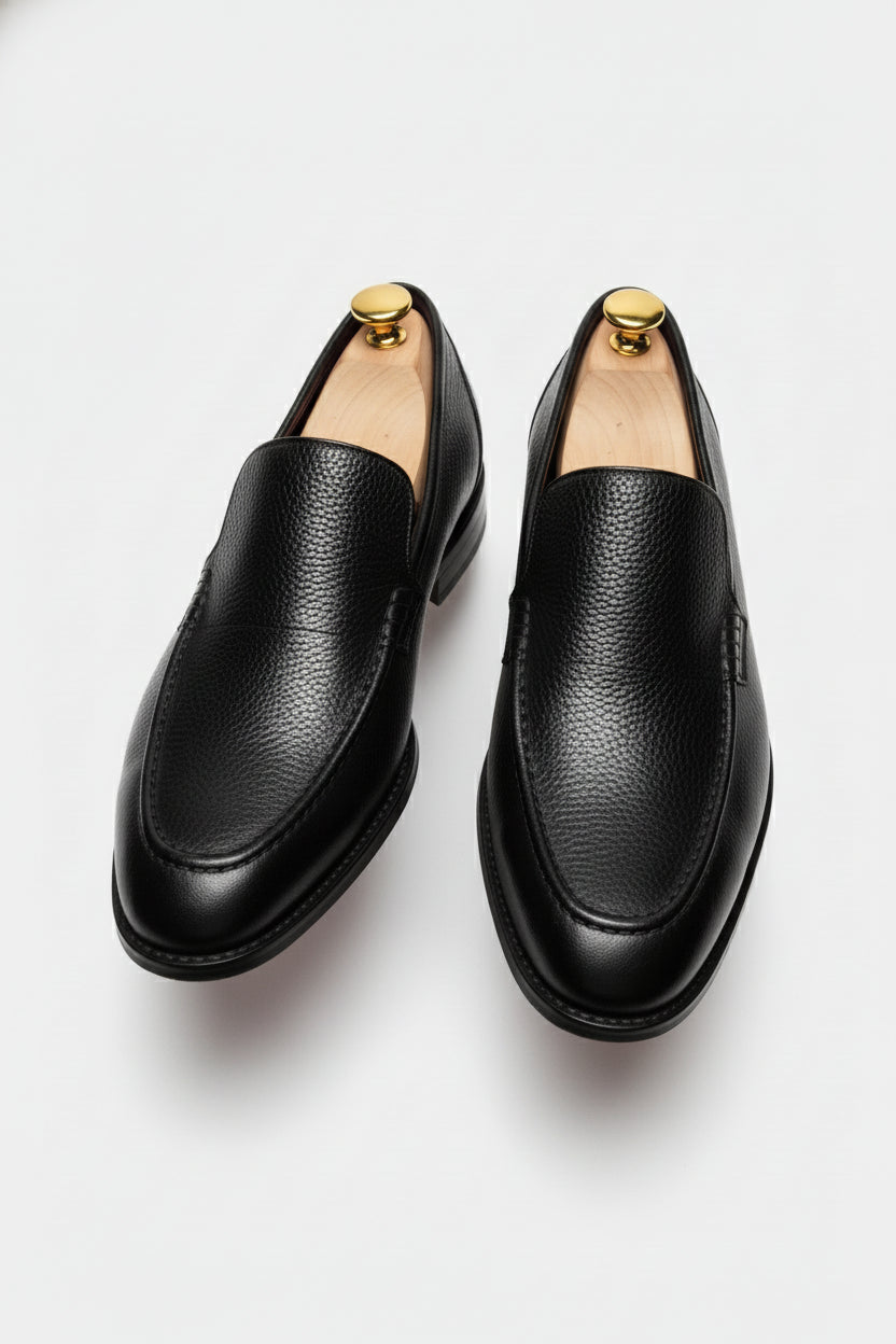 Black slip-on leather tuxedo shoes with elegant textured finish for formal events.