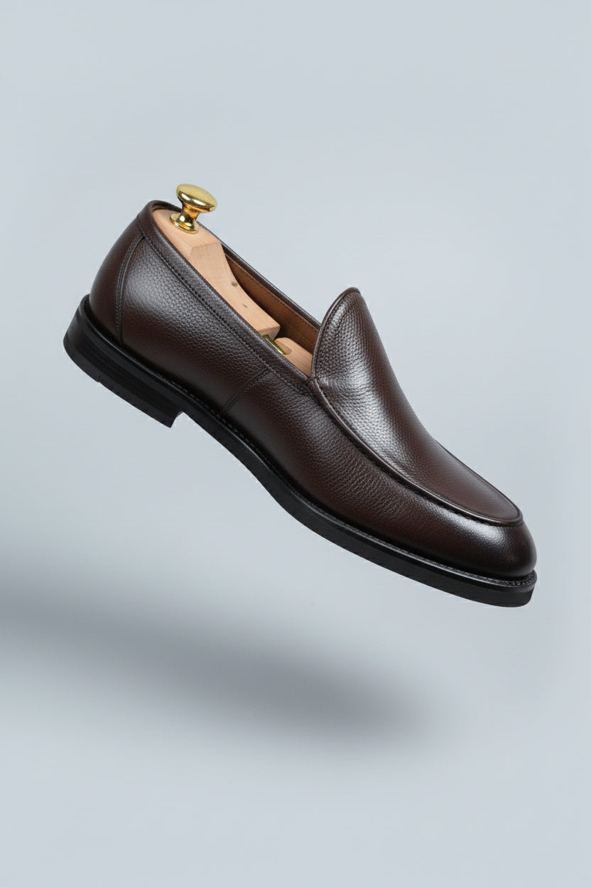 Brown slip-on leather formal shoes with textured finish, perfect for business attire.
