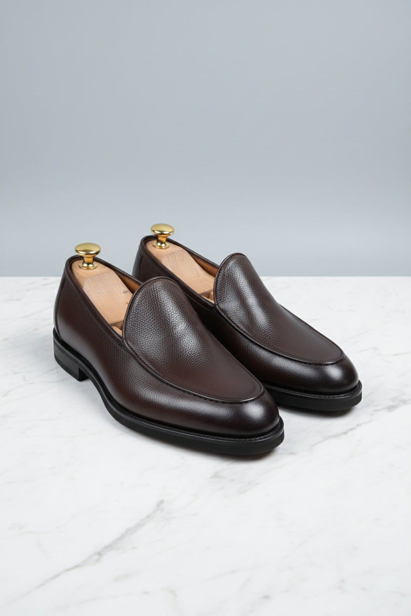 Brown slip-on leather formal shoes with elegant design and textured finish.