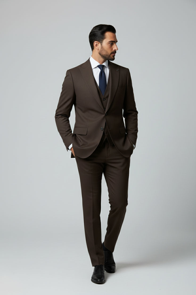 Man wearing a brown slim fit three-piece suit, ideal for formal occasions.