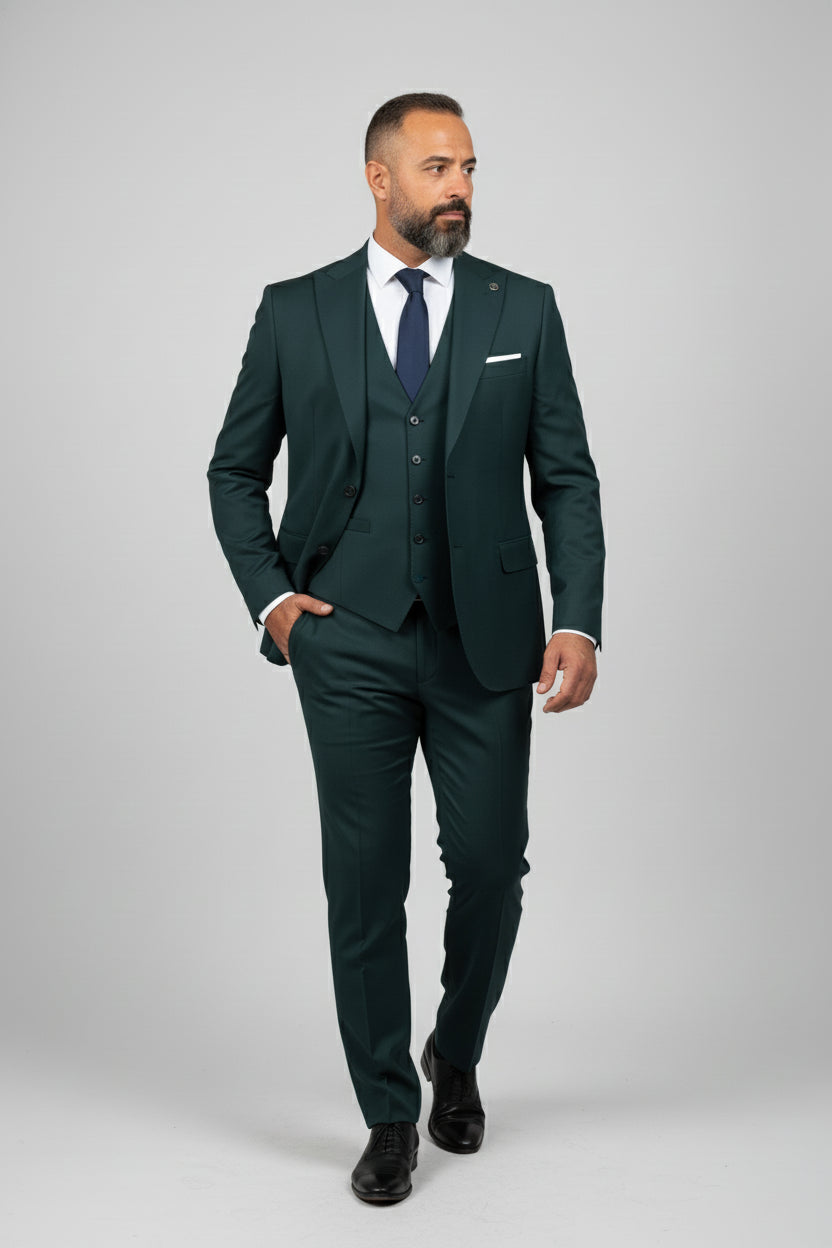 Man wearing green three-piece suit with notch lapel and tailored fit.