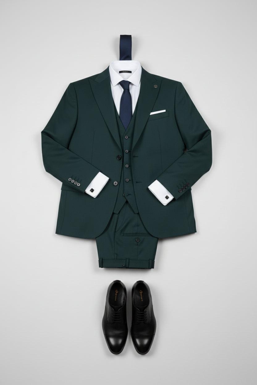 Green three-piece suit with notch lapel, tailored for modern elegance and formal occasions.