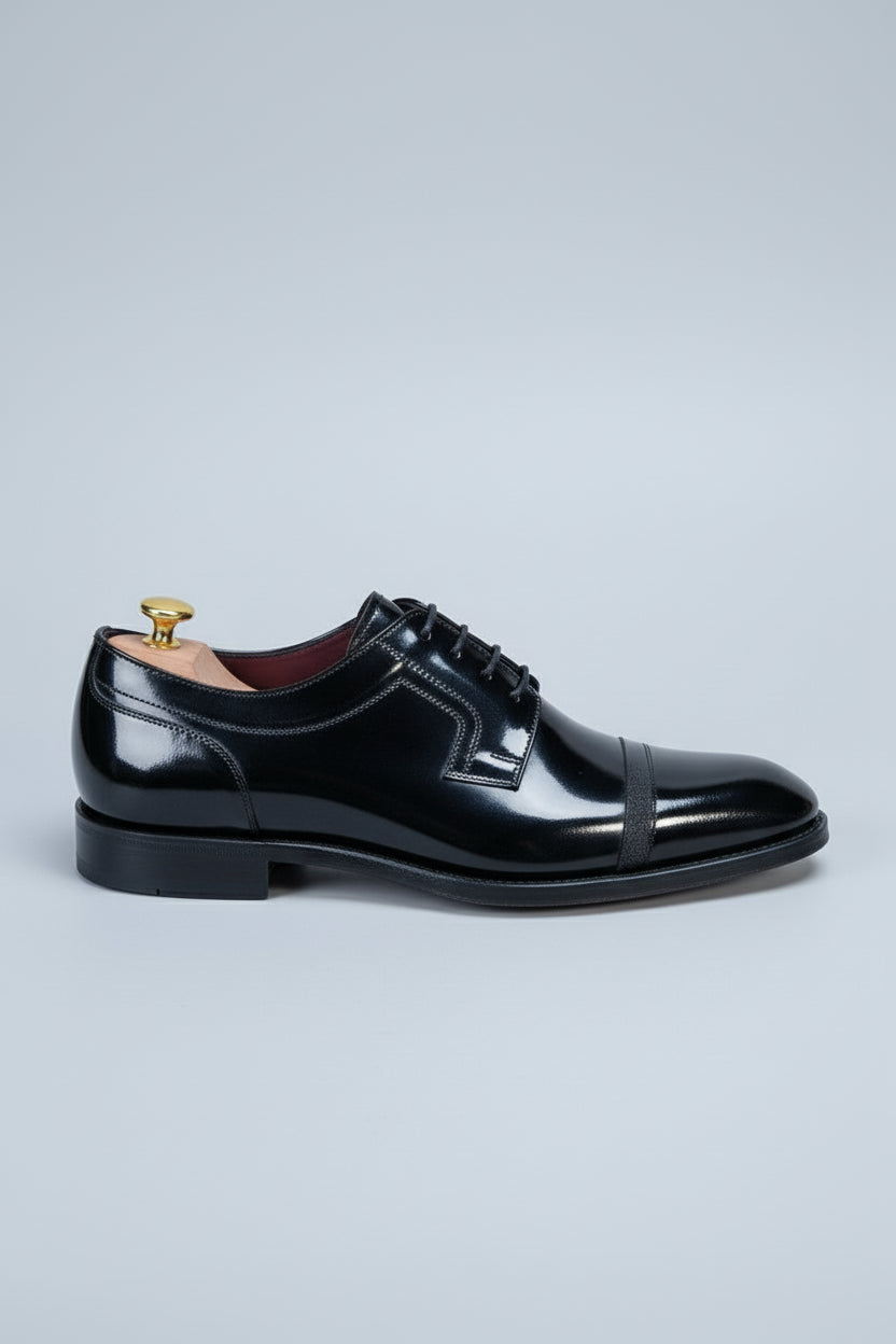 Black patent leather dress shoes with lace-up design and elegant classic style.