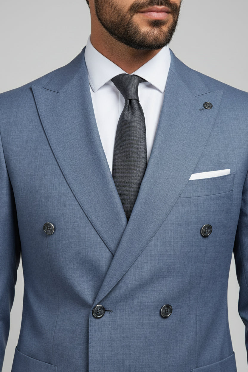 Man wearing a light blue double-breasted suit with a black tie and white shirt.