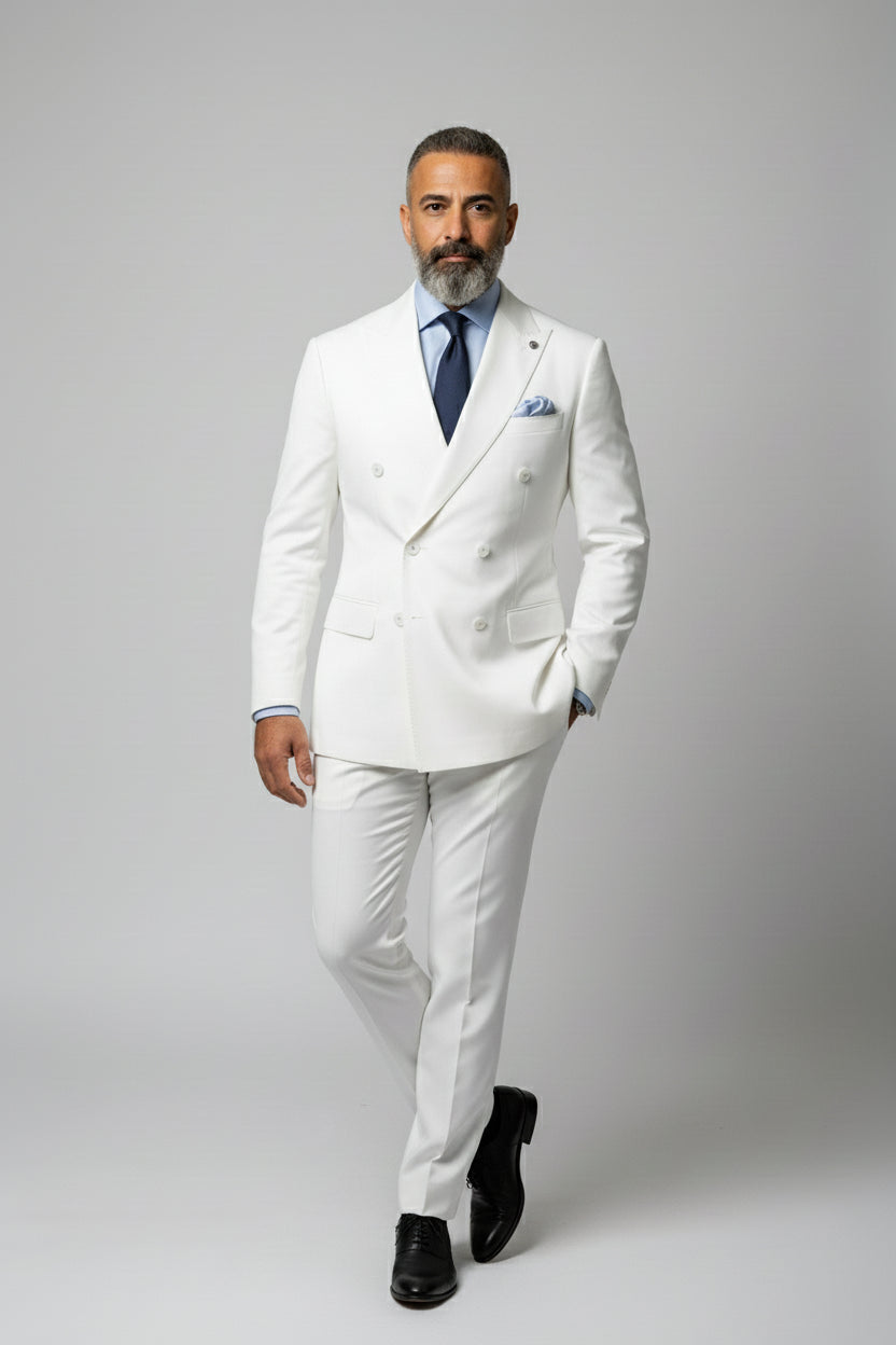 Man wearing white double-breasted dinner suit with peak lapels and tailored fit.