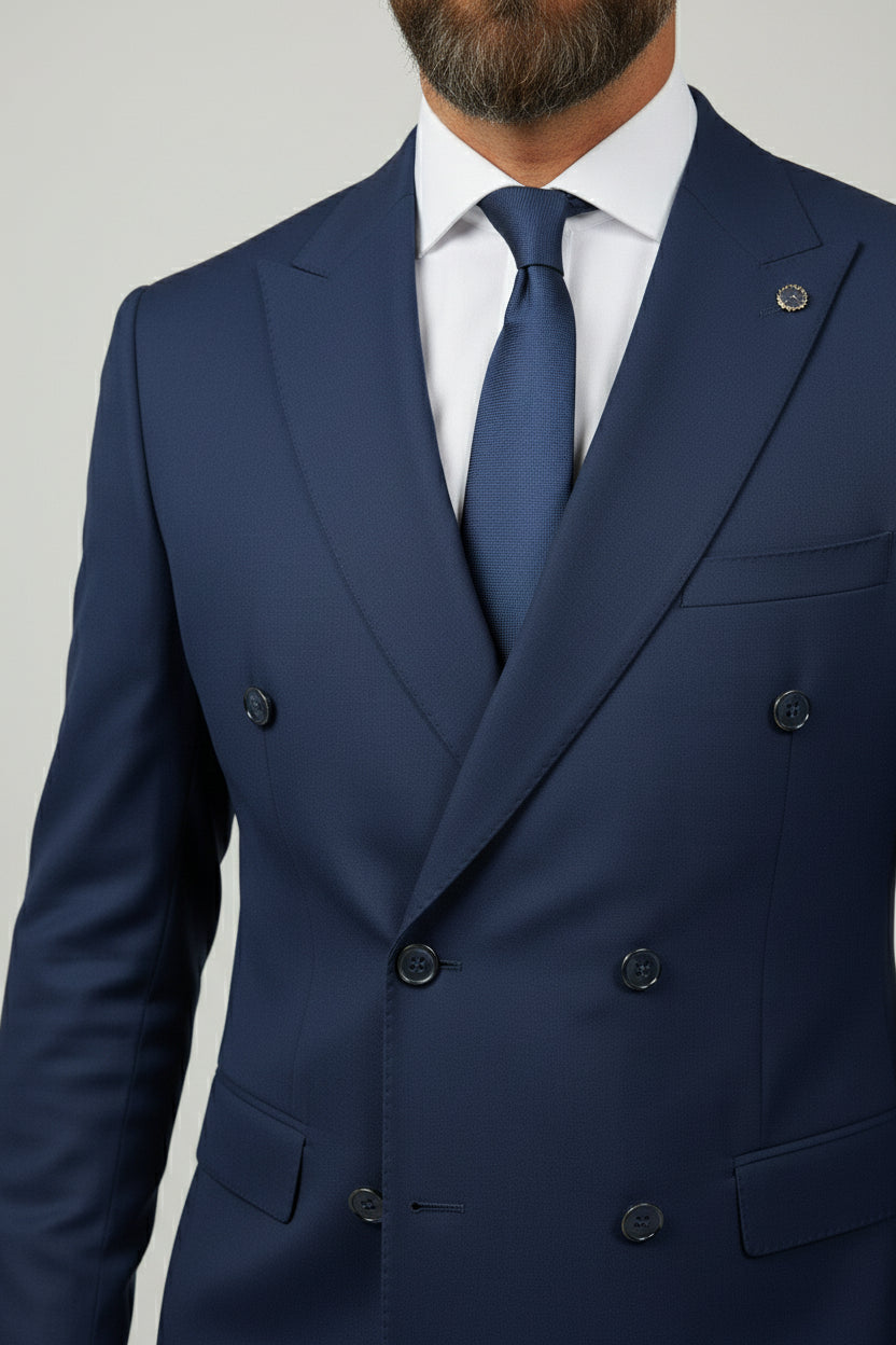 Man wearing navy double-breasted suit with tailored fit and matching tie.