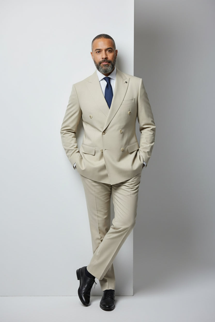 Man wearing beige double-breasted suit with peak lapels, ideal for formal events.