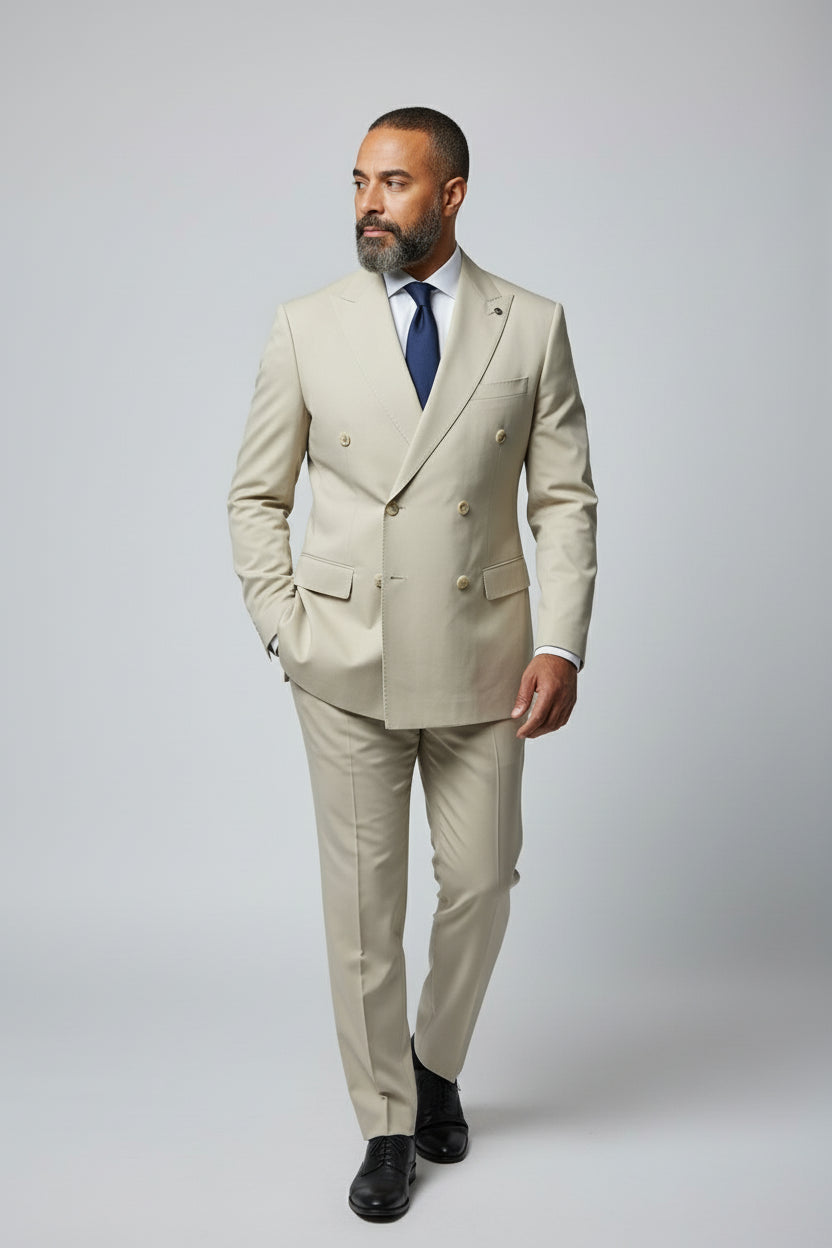 Man wearing beige double-breasted suit with peak lapels, perfect for formal events.