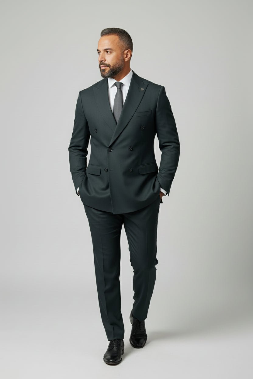 Man wearing dark green double-breasted suit with peak lapels, ideal for formal events.