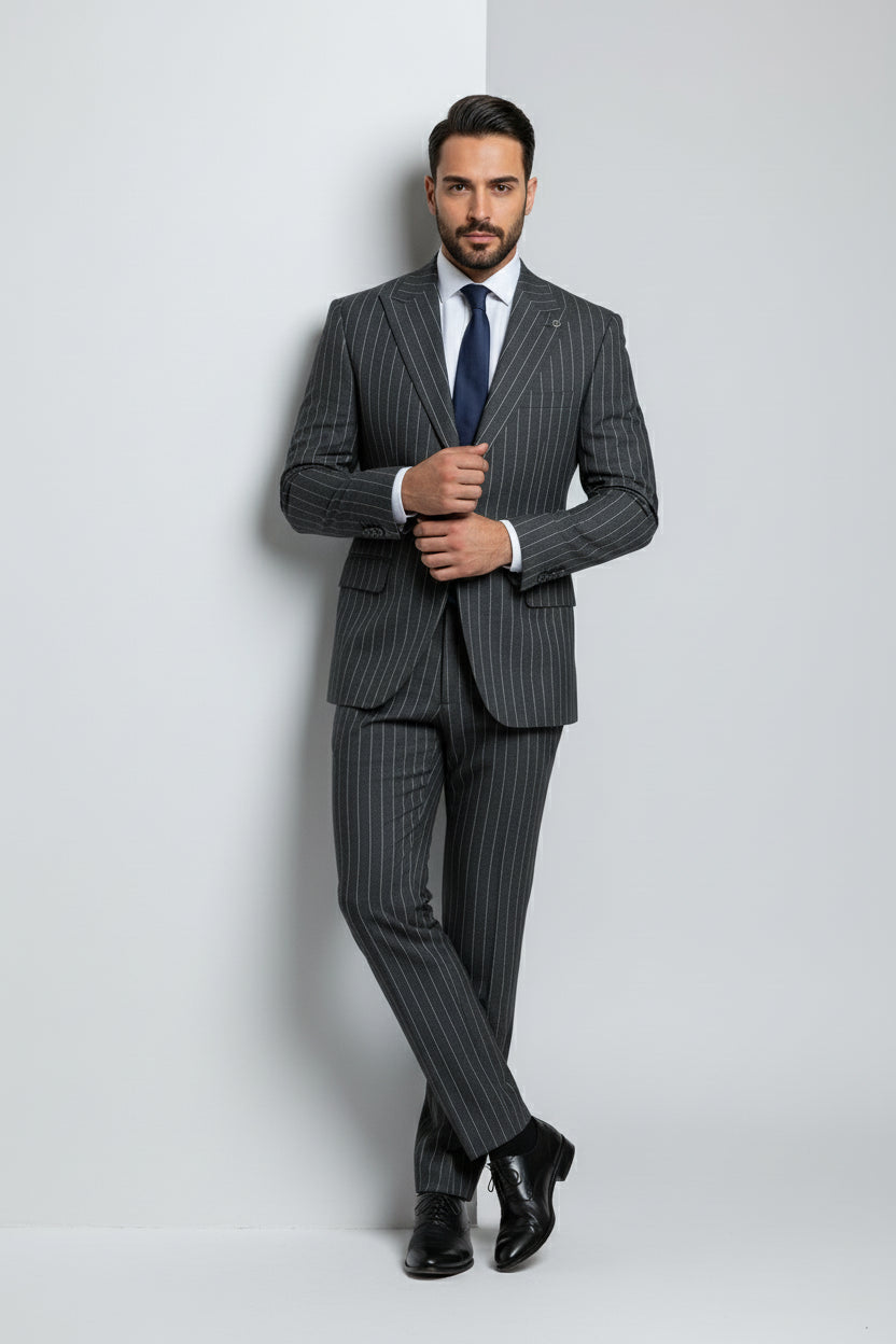 Man in charcoal pinstripe two-piece suit with tailored fit and navy tie.