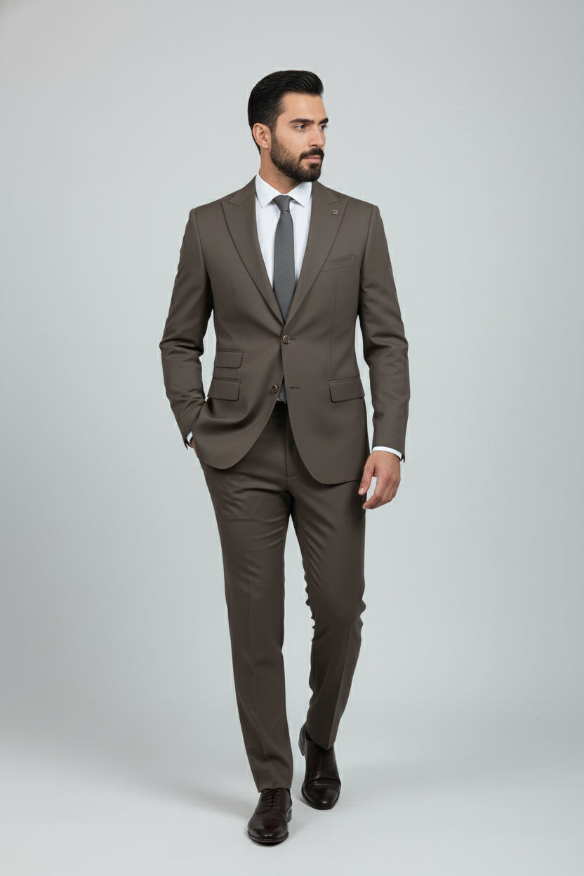 Man wearing brown tailored three-piece suit with waistcoat and tie.
