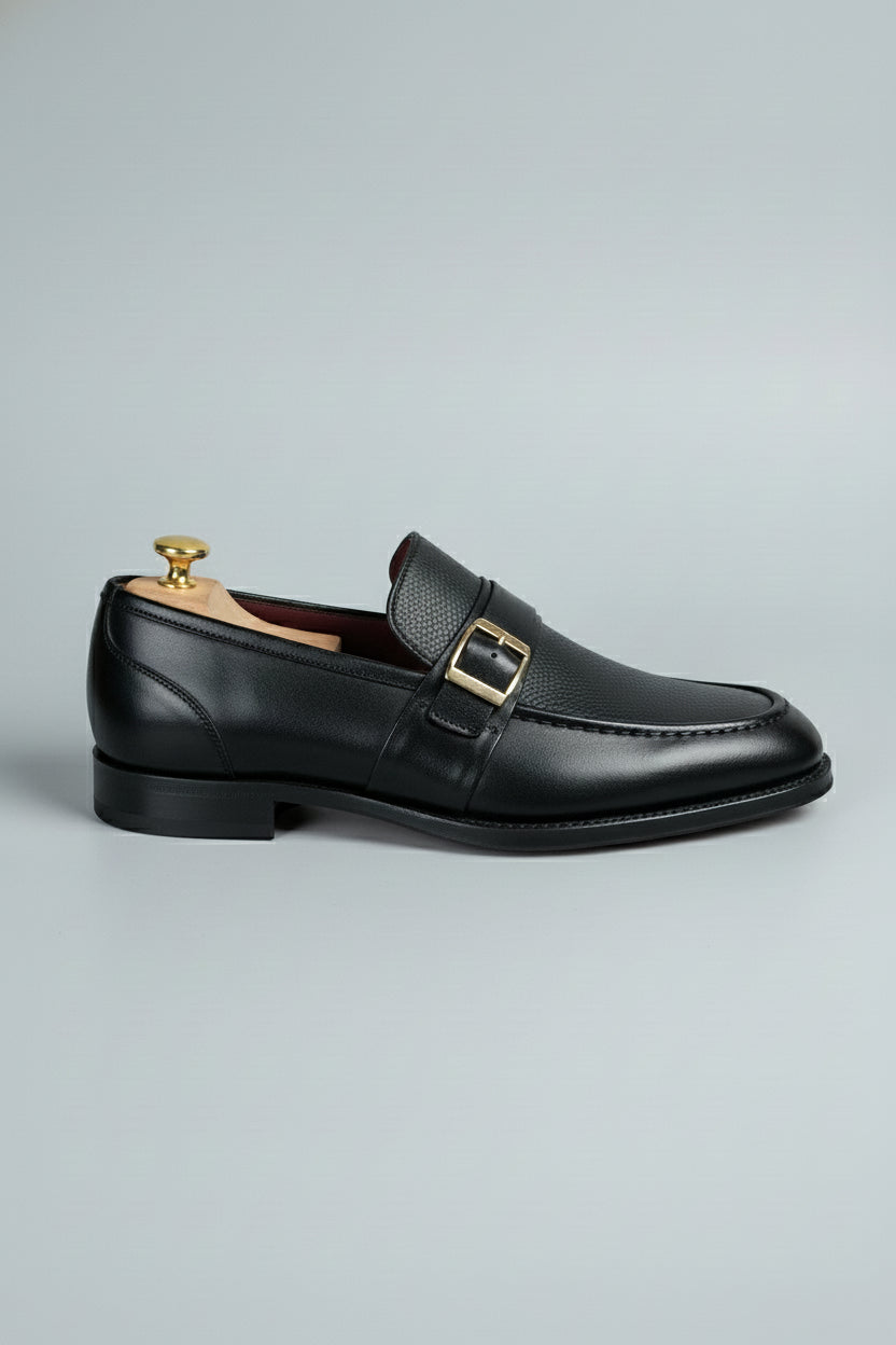 Black leather dress shoes with buckle detail, perfect for formal wear and business.