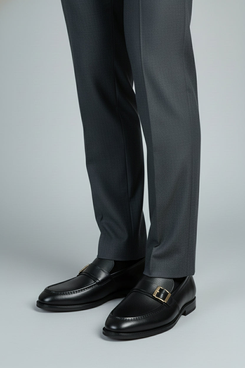 Black leather dress shoes with buckle detail, ideal for formal wear and business occasions.