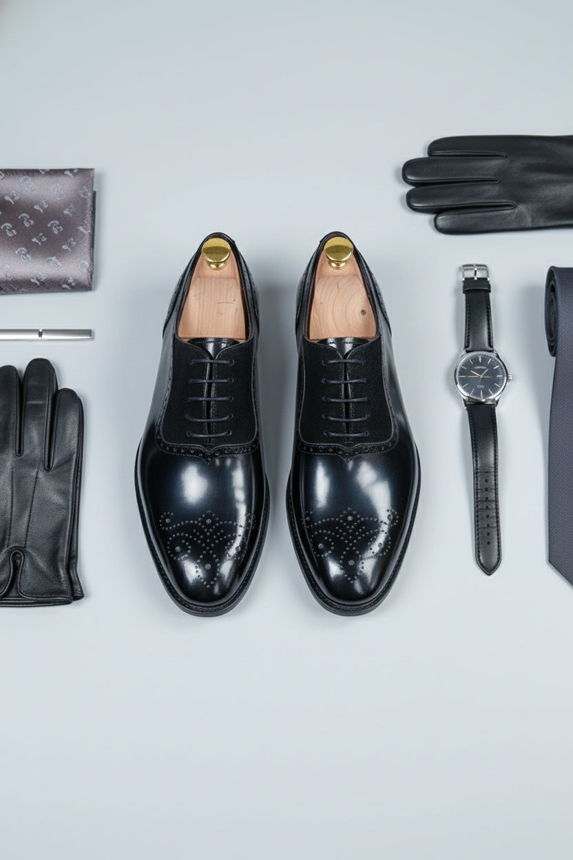 Black brogue Oxford shoes with contrast lining and decorative perforations.