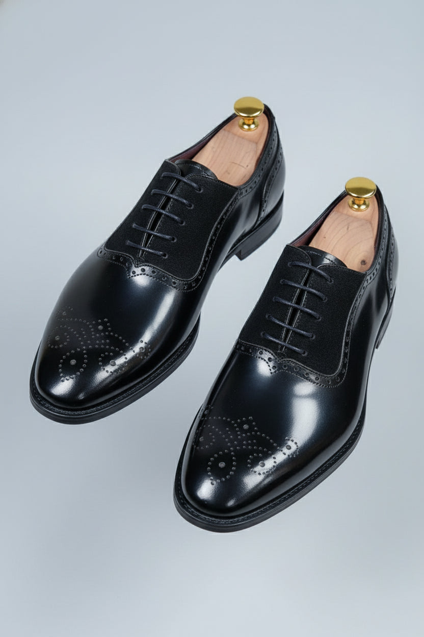 Black brogue Oxford shoes with contrast lining and elegant detailing, perfect for formal wear.