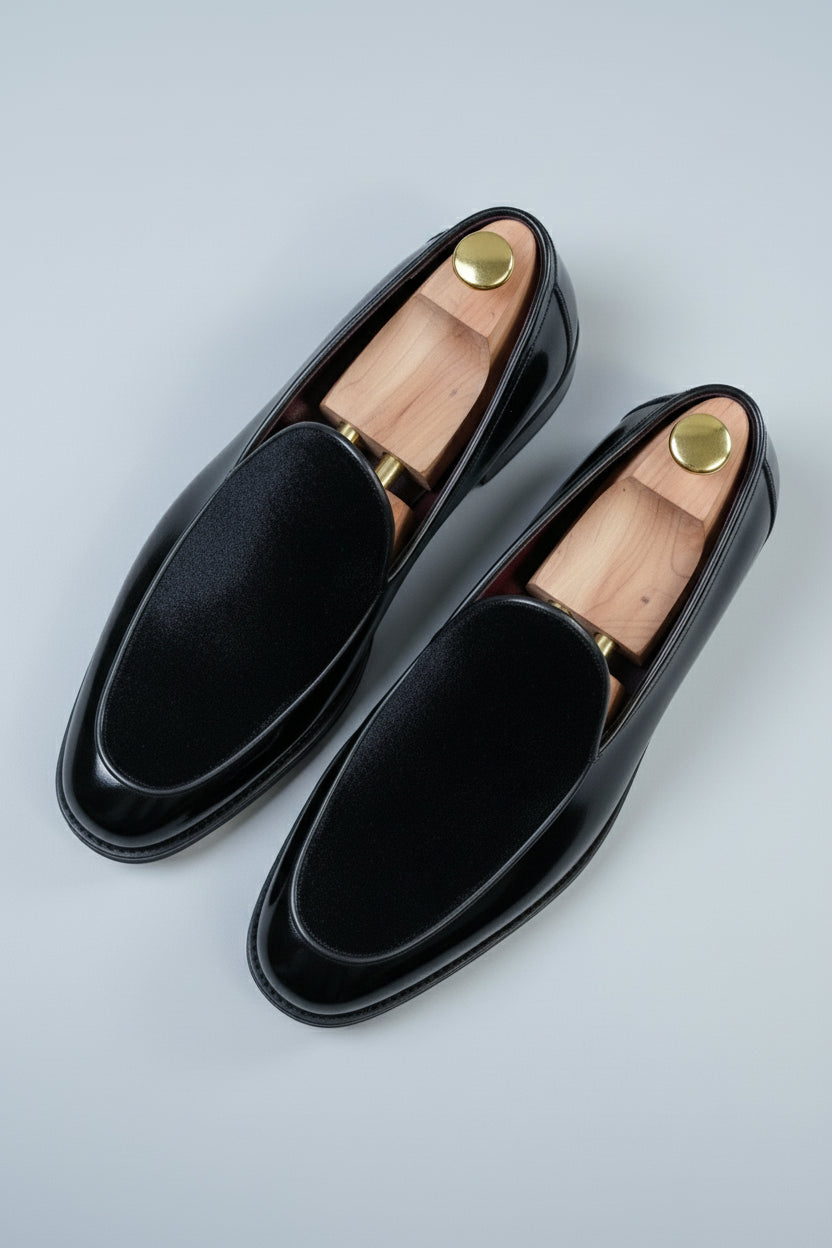 Black velvet slip-on tuxedo shoes with elegant design for formal occasions.