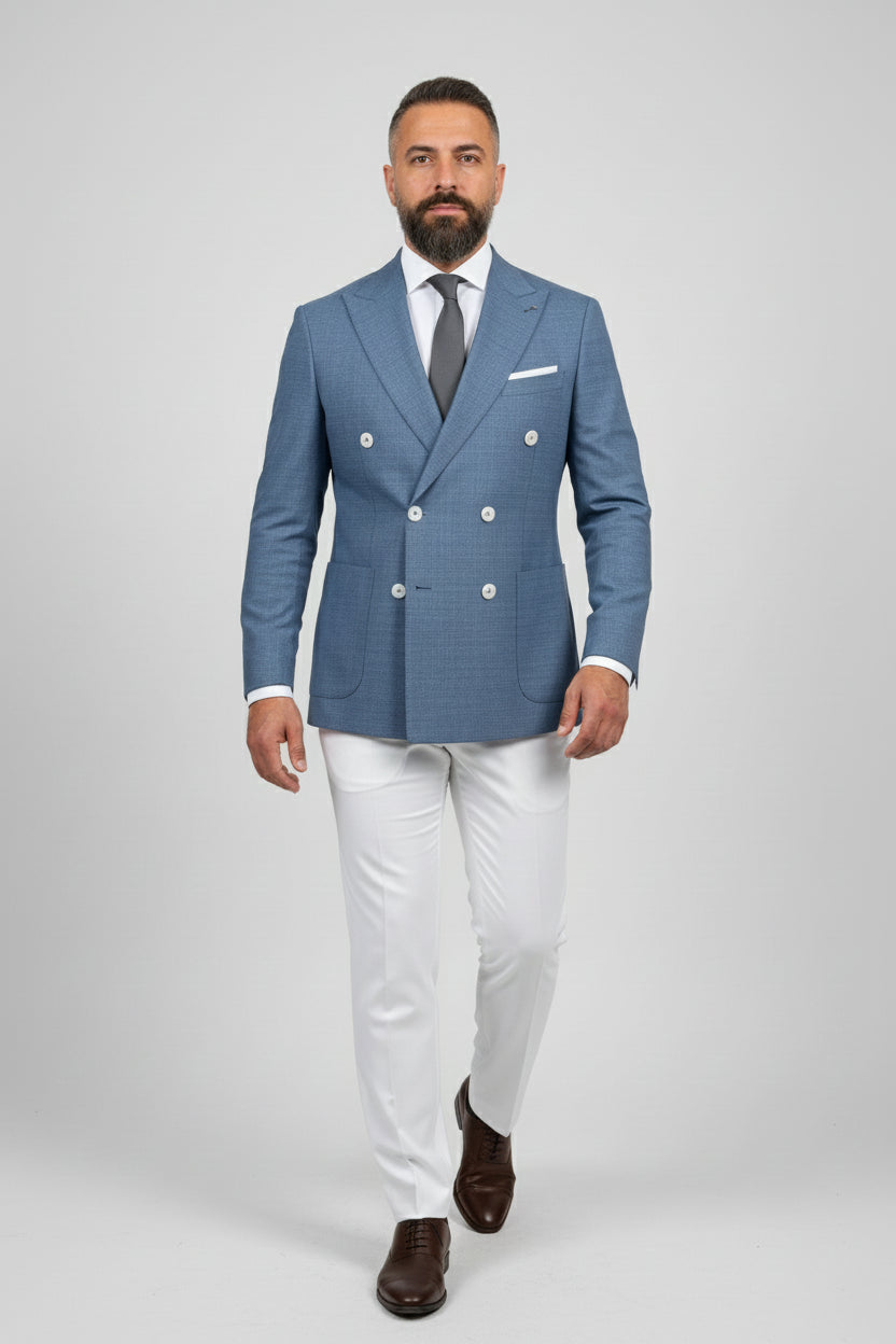 Man in midnight petrol double-breasted suit with white trousers, ideal for upscale events.