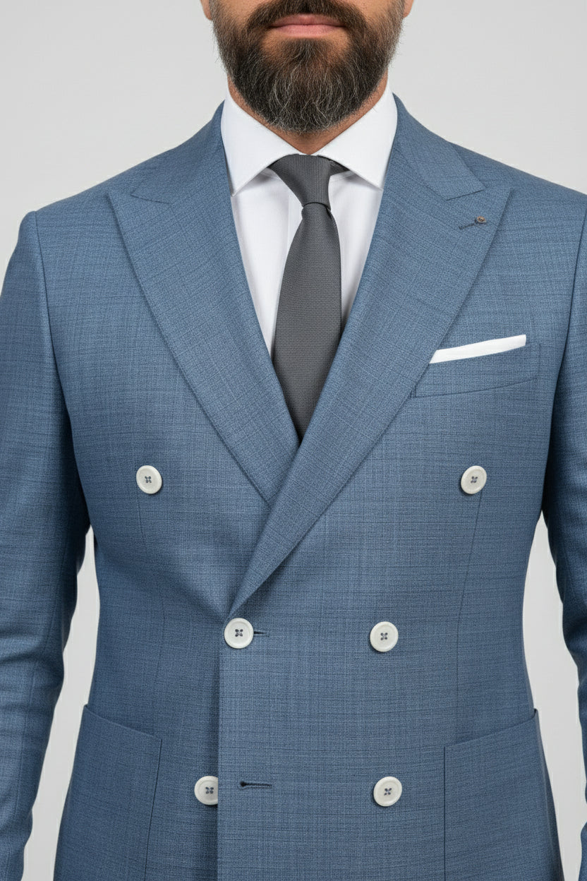 Man wearing midnight petrol double-breasted suit with textured fabric and tailored fit.