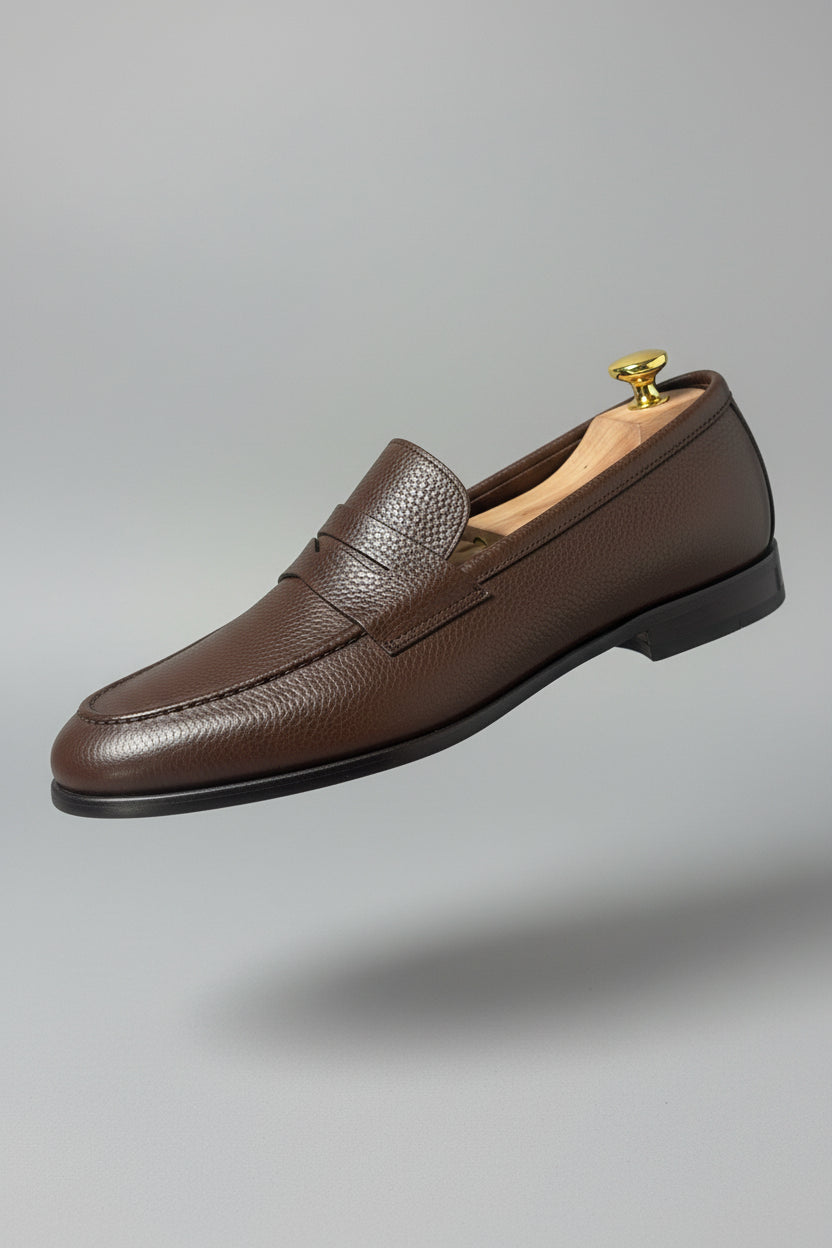 Dark brown leather slip-on loafers with textured finish, ideal for casual or office wear.