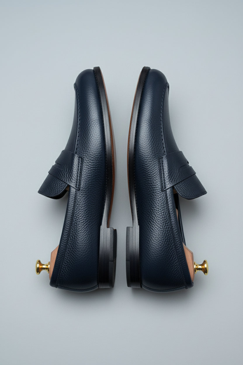Midnight blue leather loafers with textured finish, perfect for business casual wear.