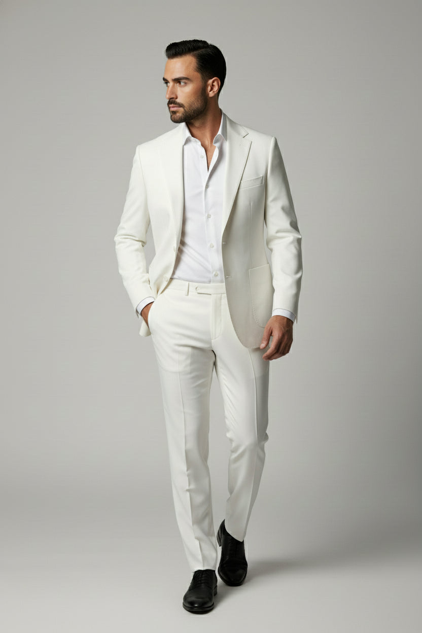 Man wearing white two-piece performance suit with peak lapels and tailored fit.