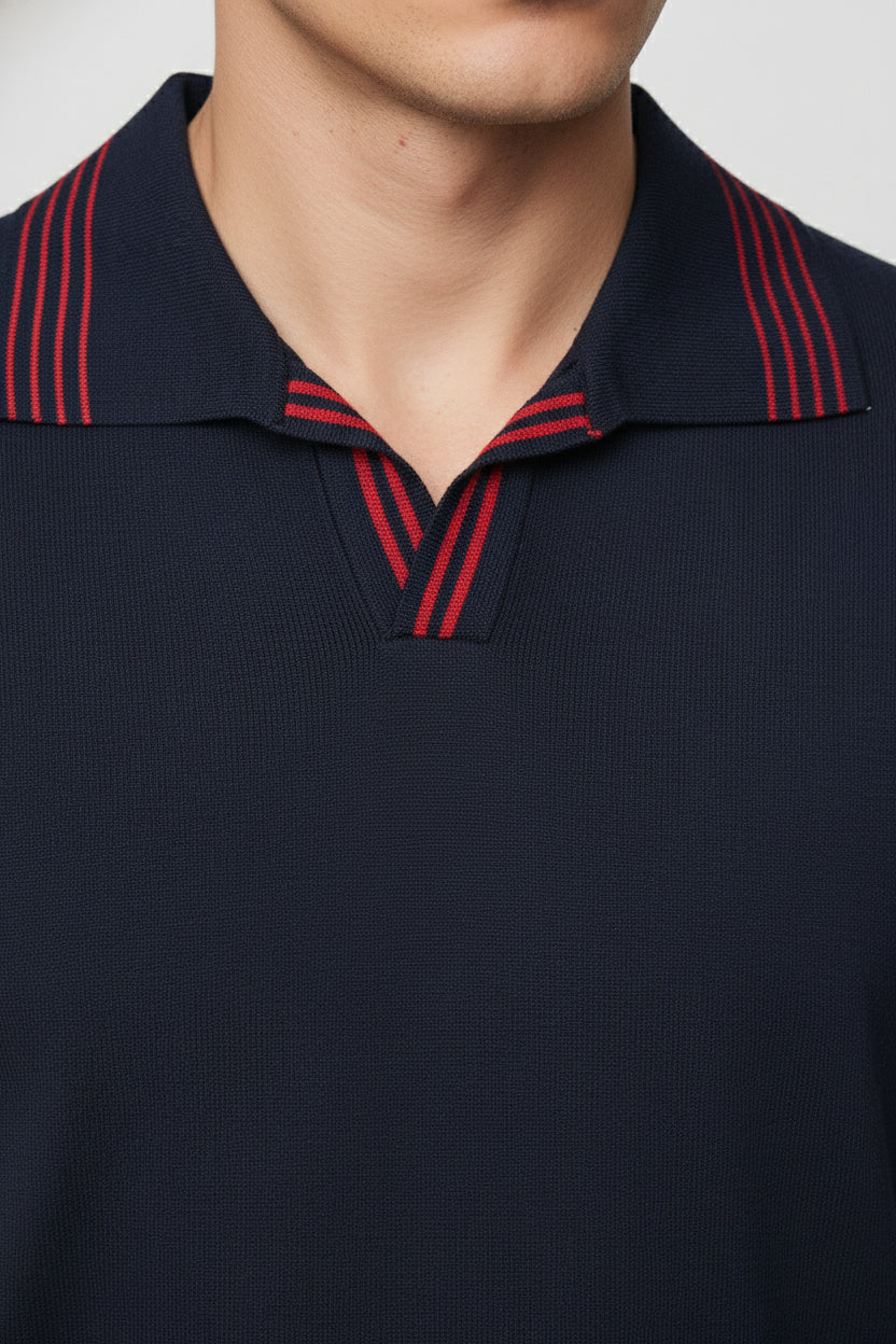 Navy knit polo with red striped collar, perfect for casual weekend wear.