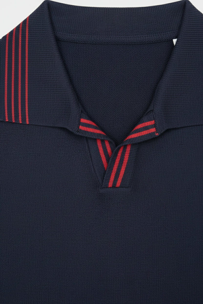Navy knit polo featuring red stripes on the collar, perfect for casual weekend wear.