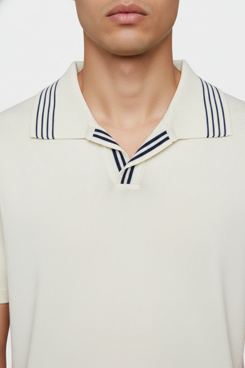White cotton polo with navy striped collar, tailored fit for casual summer wear.