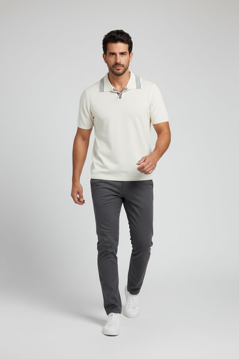 Man wearing white cotton polo with navy stripes and tailored fit, ideal for summer outings.