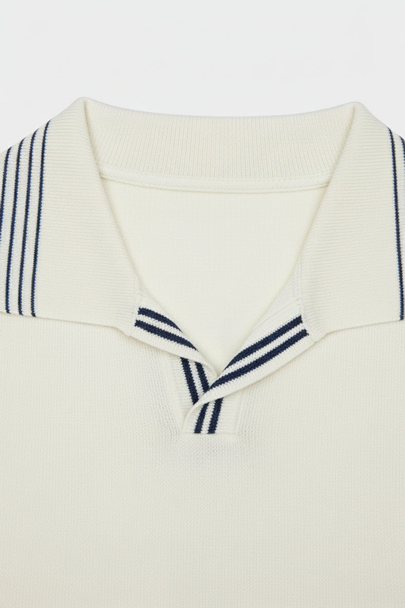 White cotton polo shirt featuring navy stripes on the collar, tailored fit for summer casual wear.