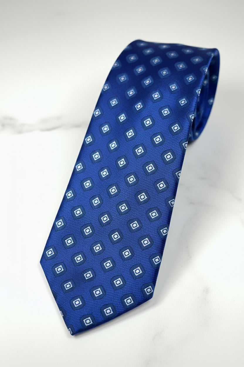 Blue silk patterned tie featuring geometric designs, perfect for formal occasions.