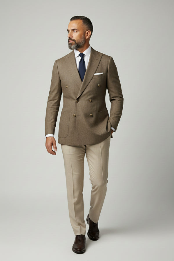 Man wearing brown double-breasted herringbone suit with tailored fit and beige trousers.