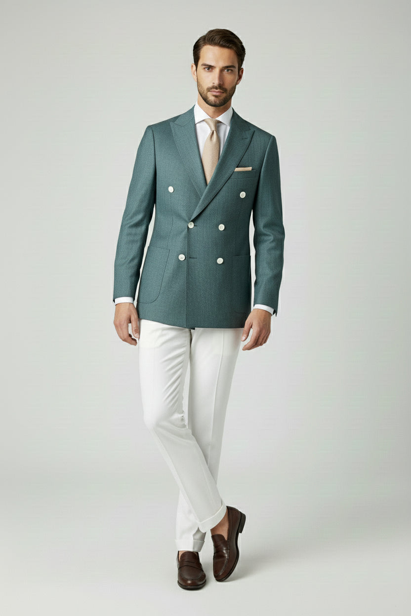 Man in deep teal double-breasted suit jacket and white dress pants.
