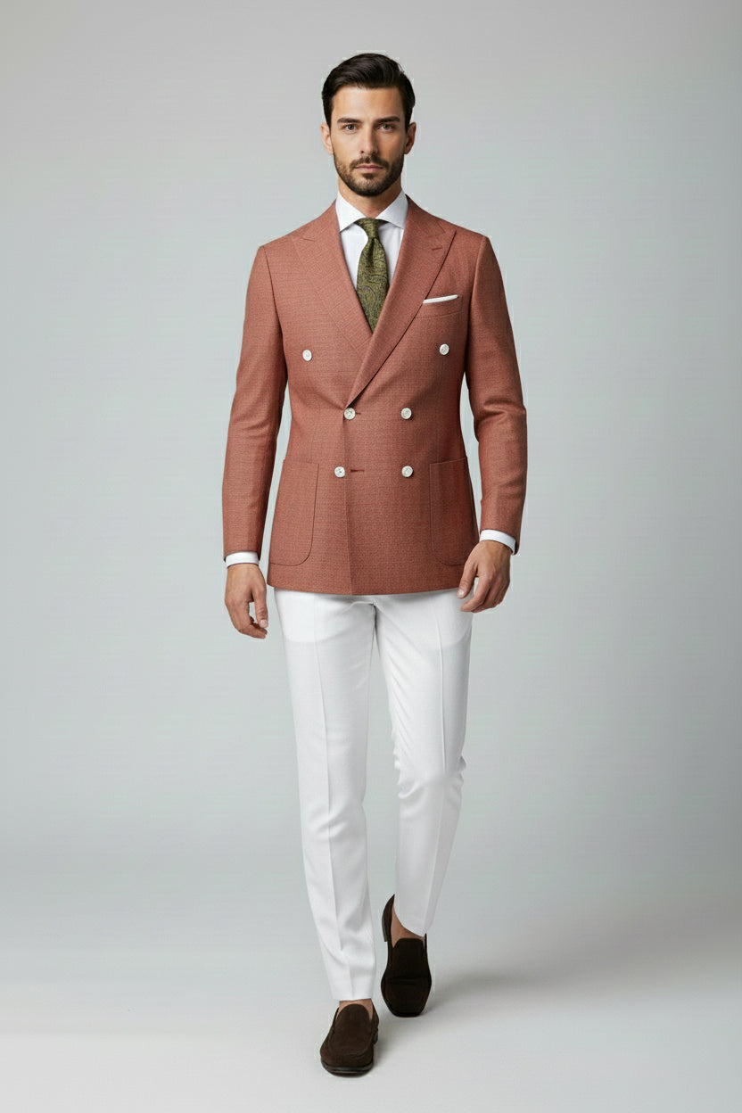 Man wearing terracotta double-breasted suit with elegant buttons and slim-fit design.