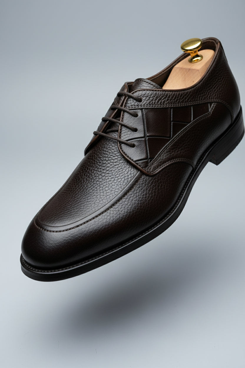 Brown leather lace-up dress shoes with textured finish for formal occasions.