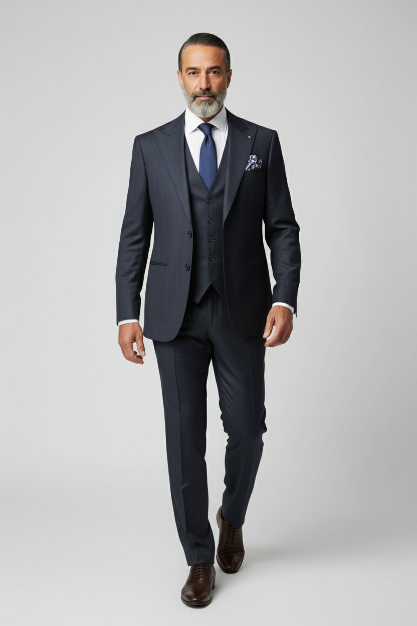 Man wearing navy pinstripe three-piece suit with a tailored fit and matching tie.
