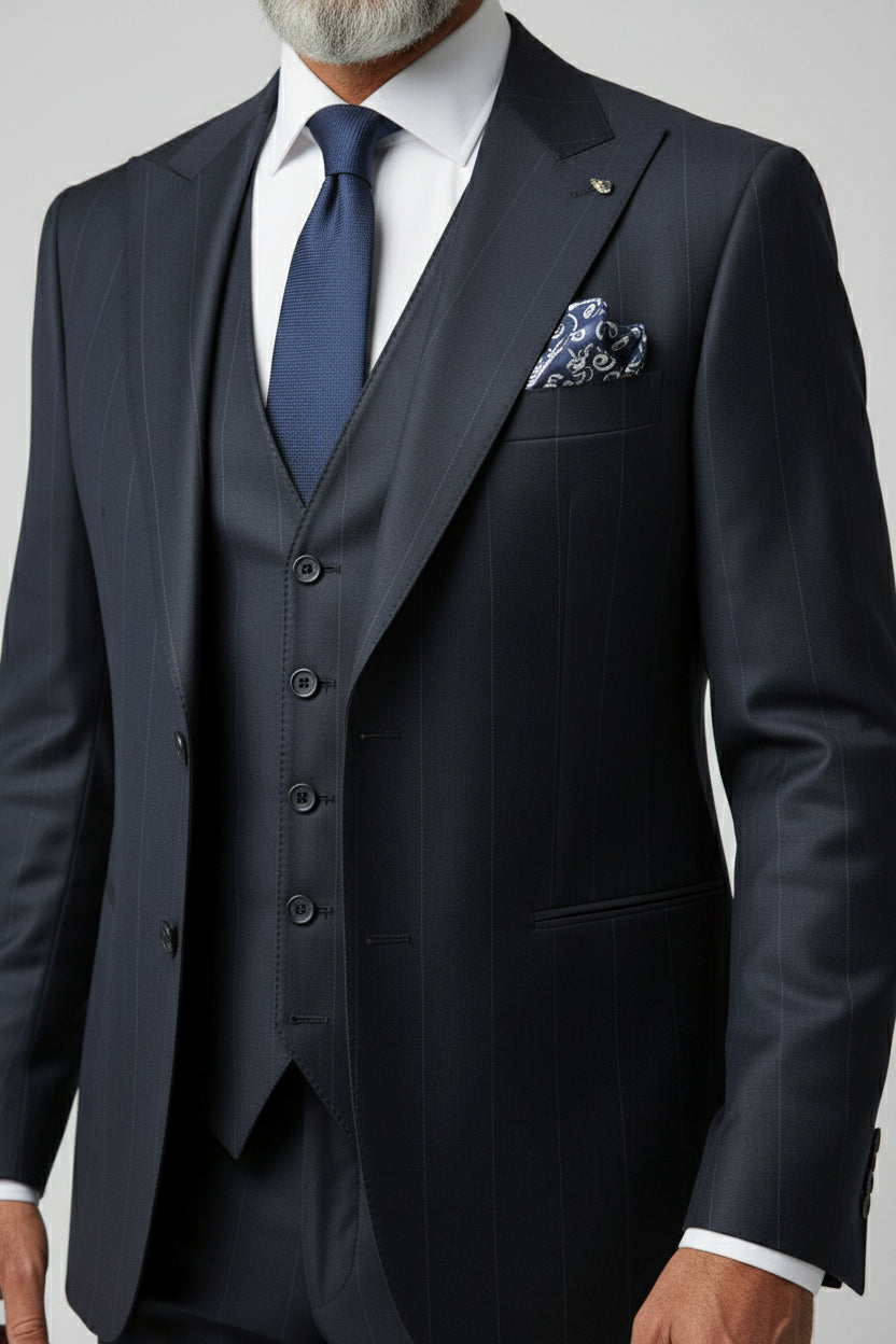Man in navy pinstripe three-piece suit with vest and patterned pocket square.
