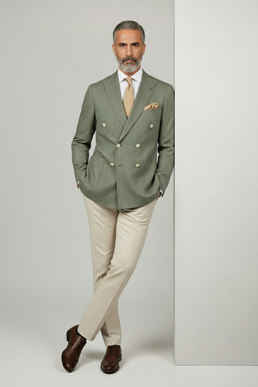 Man in sage green double-breasted linen blend suit with beige trousers and tie.
