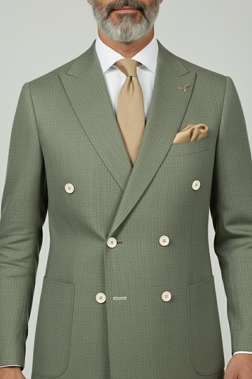 Man wearing sage green double-breasted linen blend suit with beige tie and pocket square.