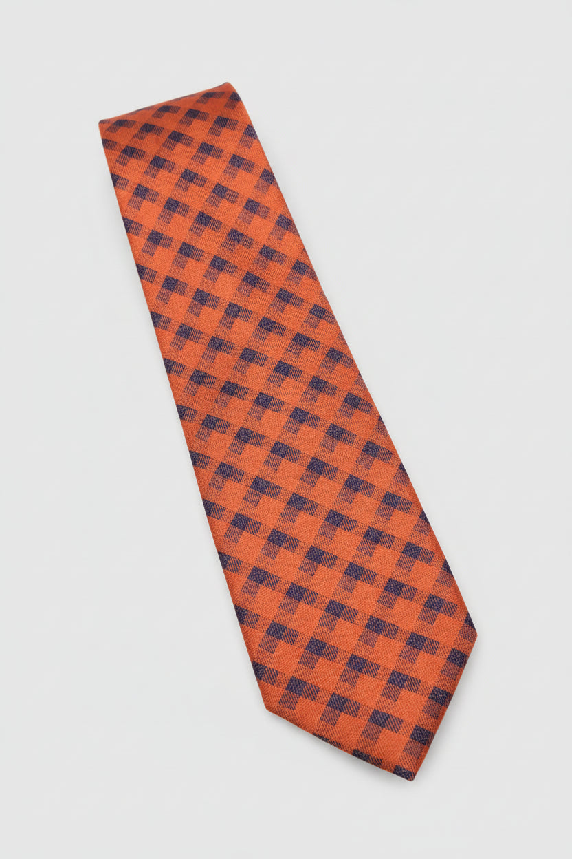 Red geometric pattern silk tie with navy accents, ideal for formal occasions.