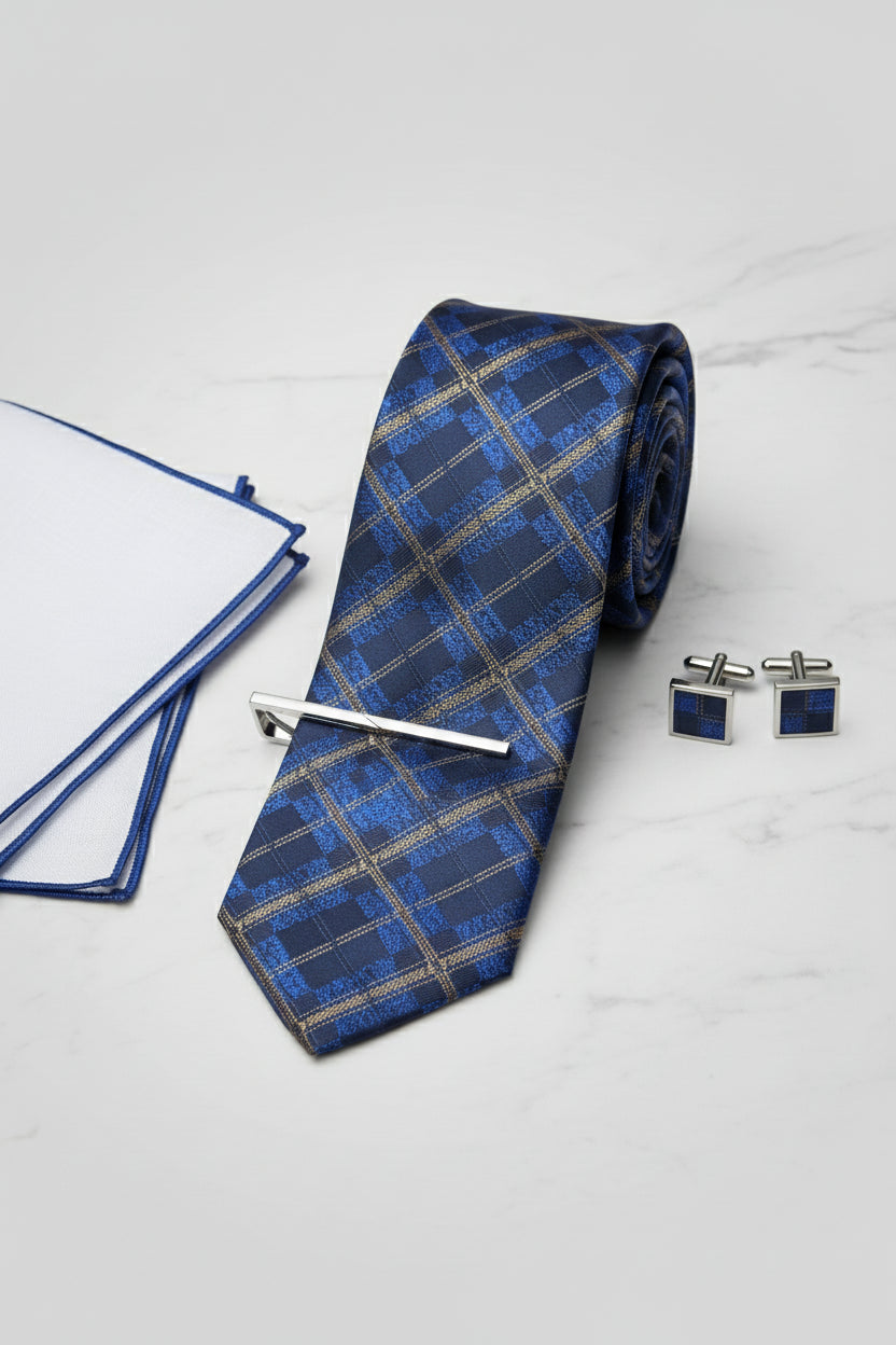 Navy and gold plaid silk tie with tie clip, accompanied by white pocket square.